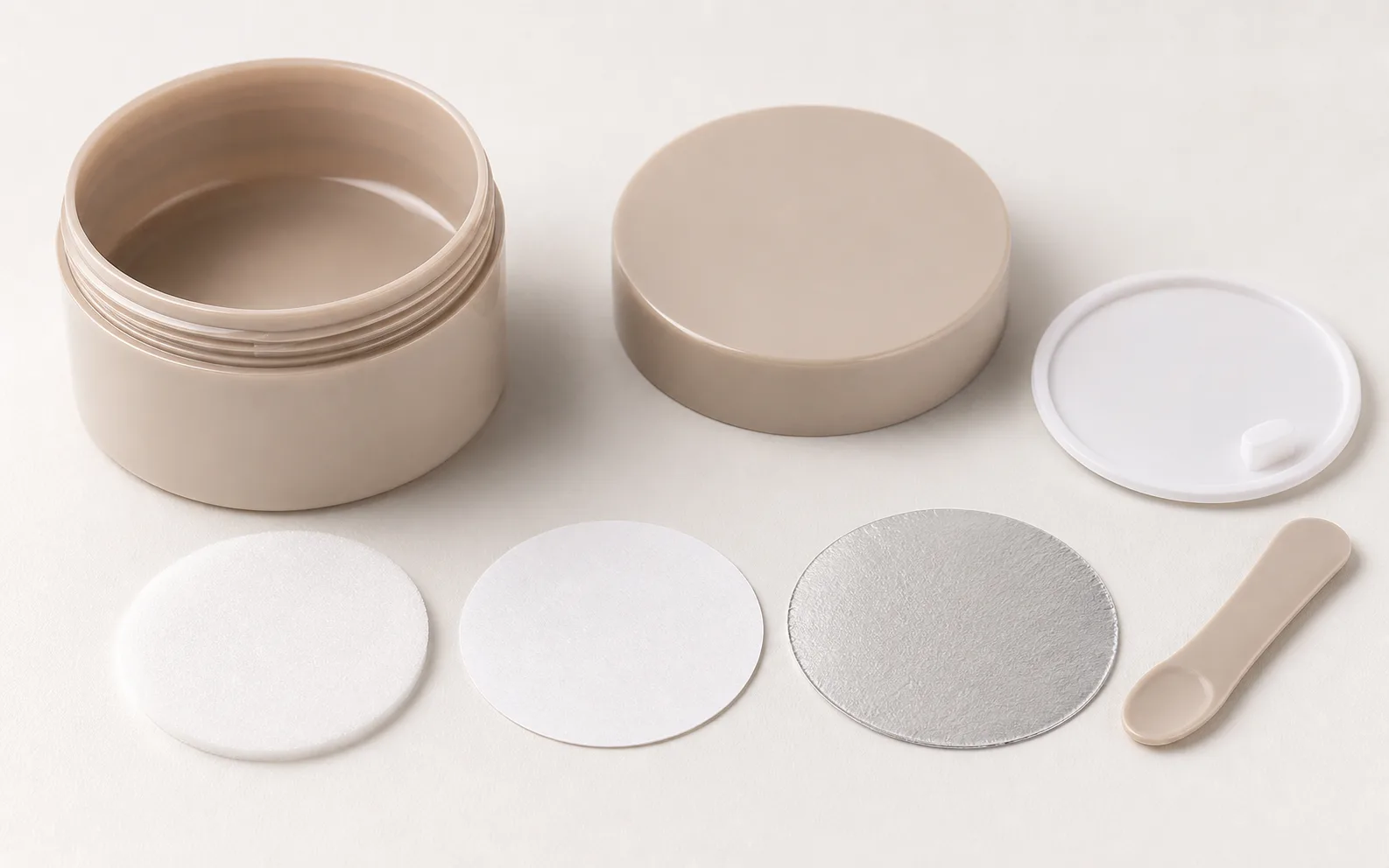 Plastic cosmetic jar assembly with lid, liner, inner disc, seal, and spatula components